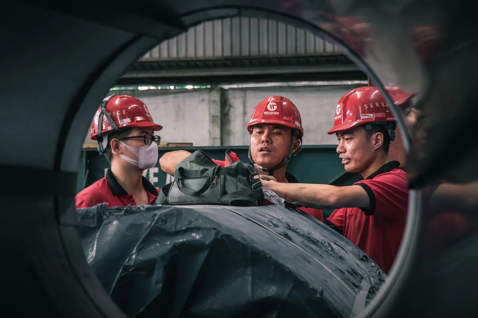 Engineers reviewing data on a tablet inside an industrial plant