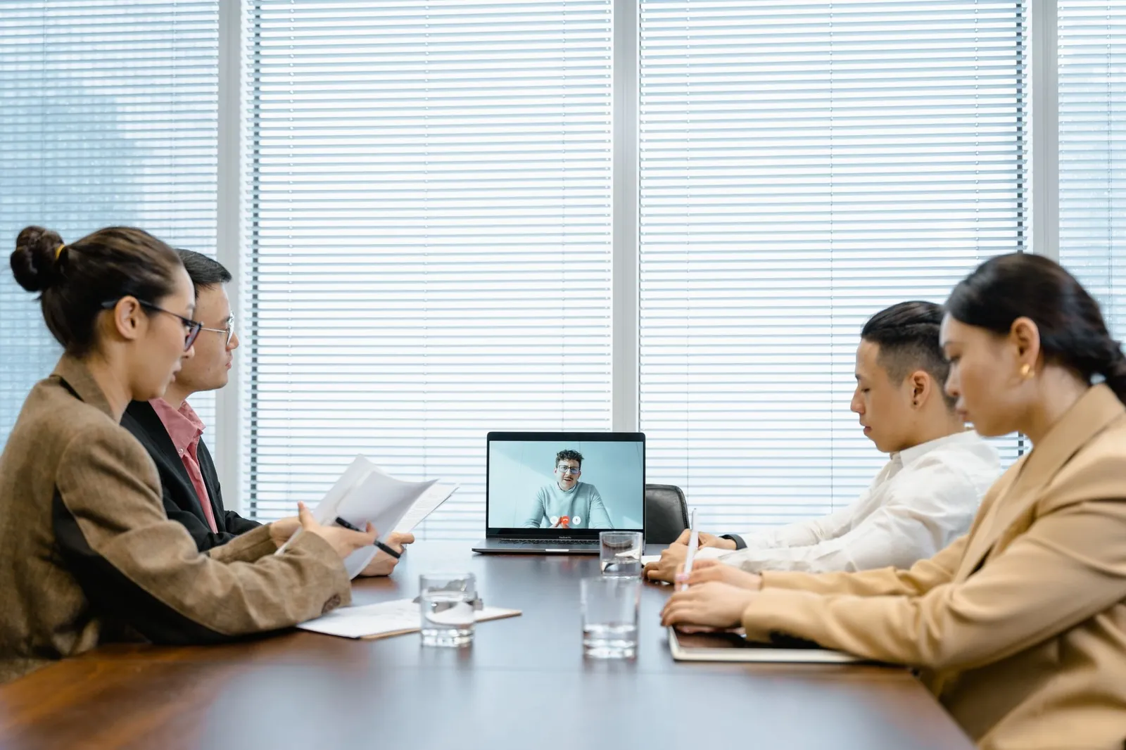 A distributed team meeting over video from a conference room
